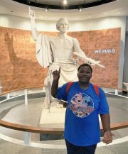 Michael Tadi with statue Michael Tadi with statue